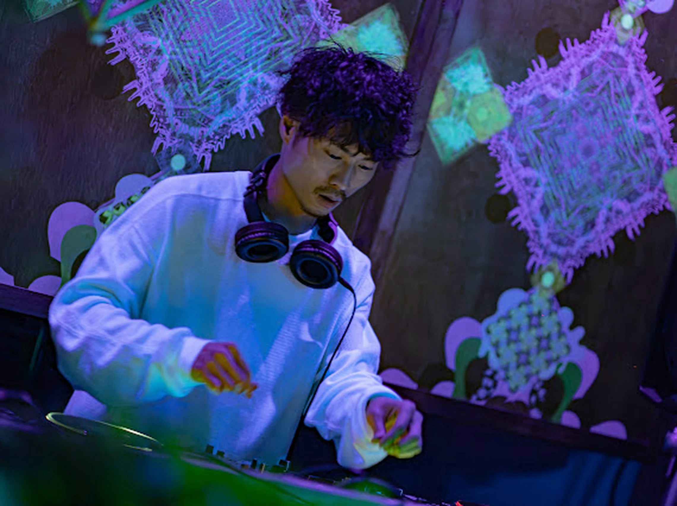 WOLT behind the decks under ultraviolet light